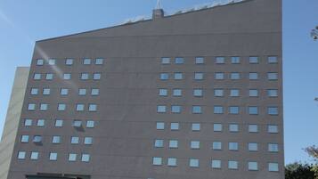 A modern building with a flat roof and numerous windows.