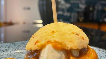 A dessert with a biscuit and caramel sauce on a speckled plate.