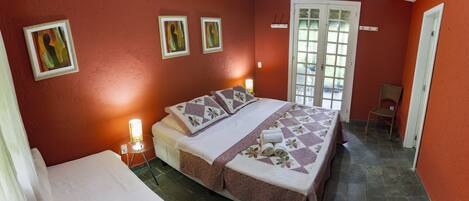A bedroom with a bed, a chair, and a door.