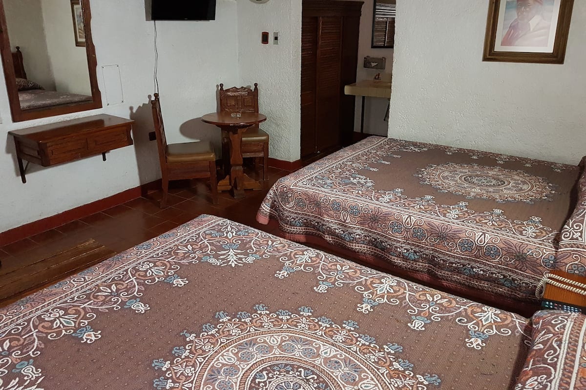 Escritorio, cortinas blackout y tabla de planchar con plancha