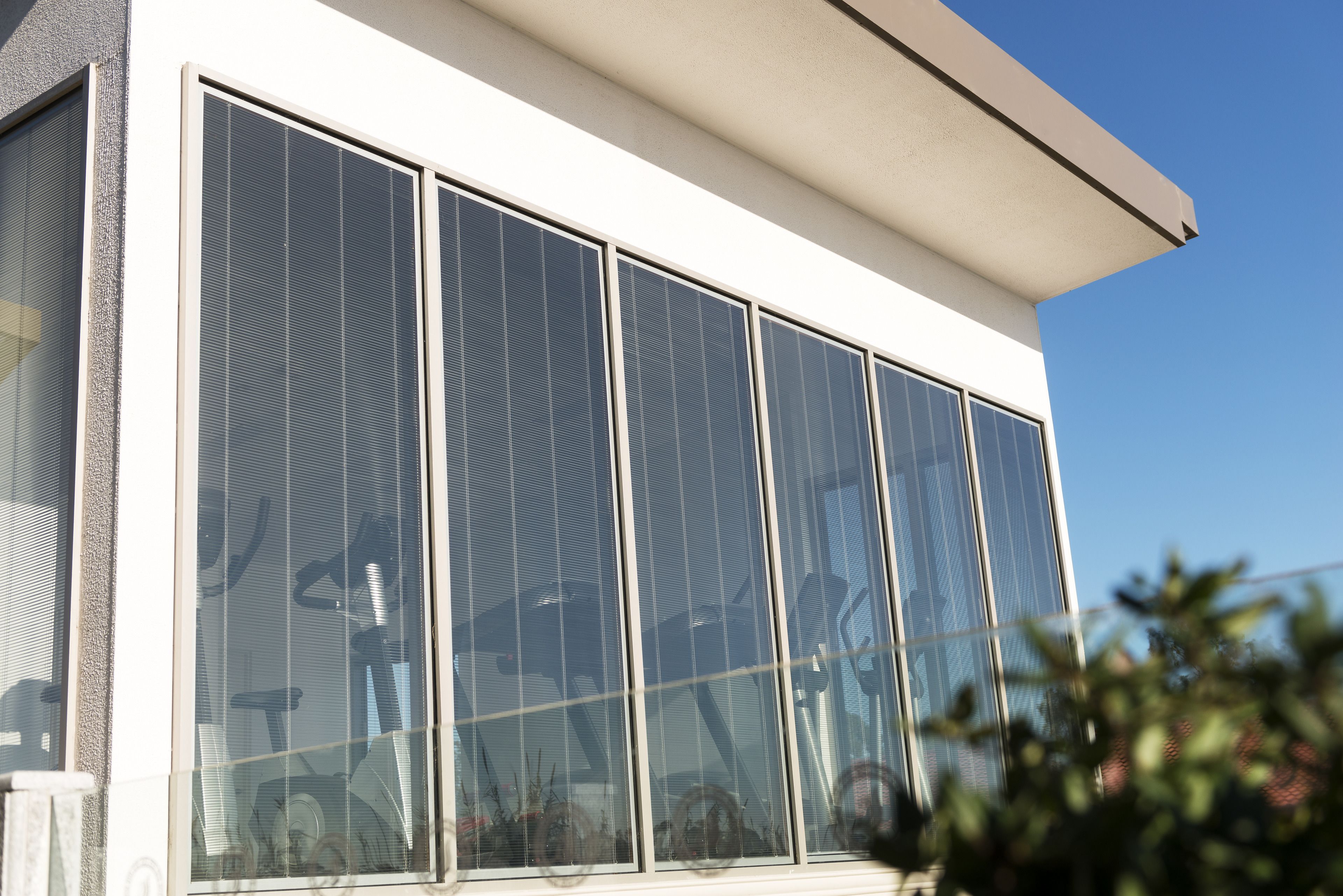 A modern building with large windows and a white facade.