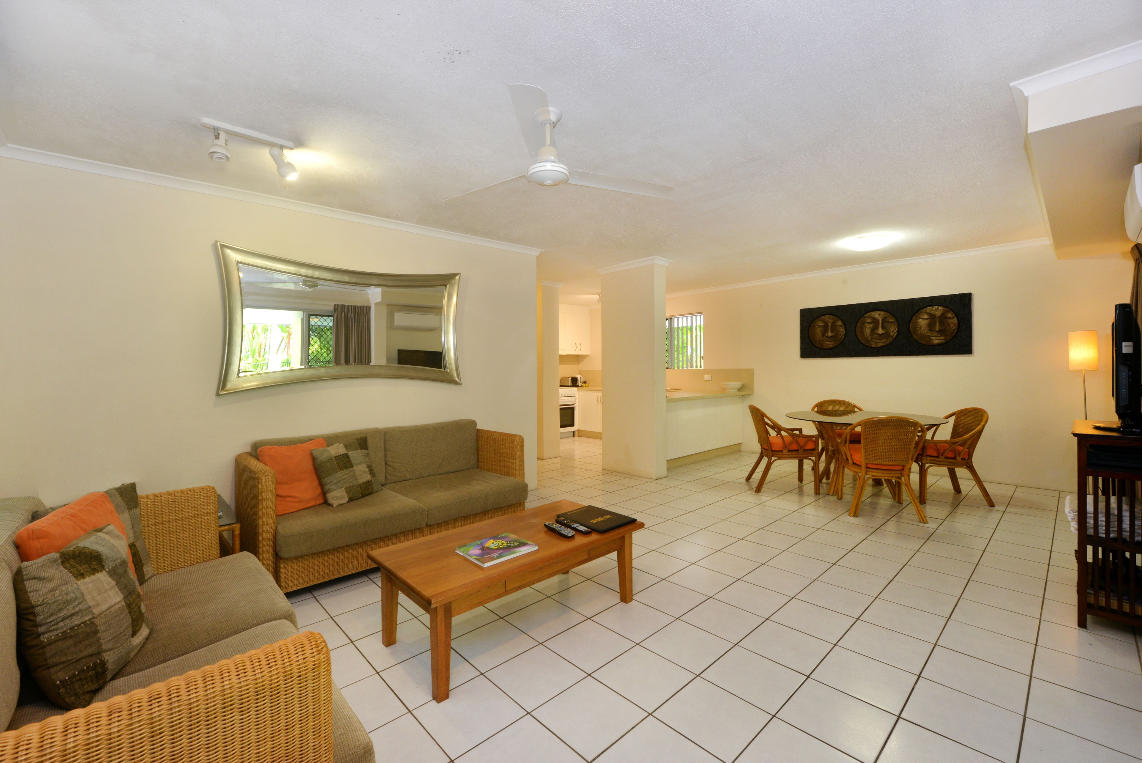 A spacious living room with a sofa, coffee table, and dining area.