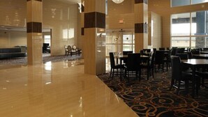 A spacious hotel lobby with a polished floor, large windows, and a patterned carpet. - Days Inn & Suites by Wyndham Fort Saskatchewan (Fort Saskatchewan)