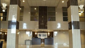 A hotel lobby with a reception desk, chandeliers, and a large sign reading "Stars". - Days Inn & Suites by Wyndham Fort Saskatchewan (Fort Saskatchewan)