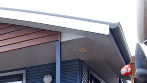 A curved architectural feature with horizontal wooden slats. - Strahan Bungalows (Strahan)