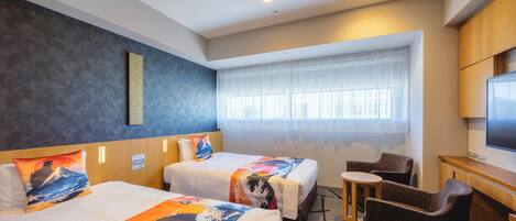 A hotel room with two beds, a desk, a chair, and a large window with sheer curtains.