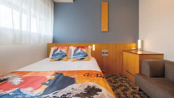 A hotel room with a bed, a wooden headboard, a bedside table, and a chair.