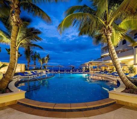 On the beach, white sand, beach cabanas, sun loungers