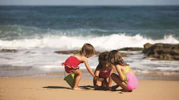 On the beach, white sand, beach cabanas, sun loungers