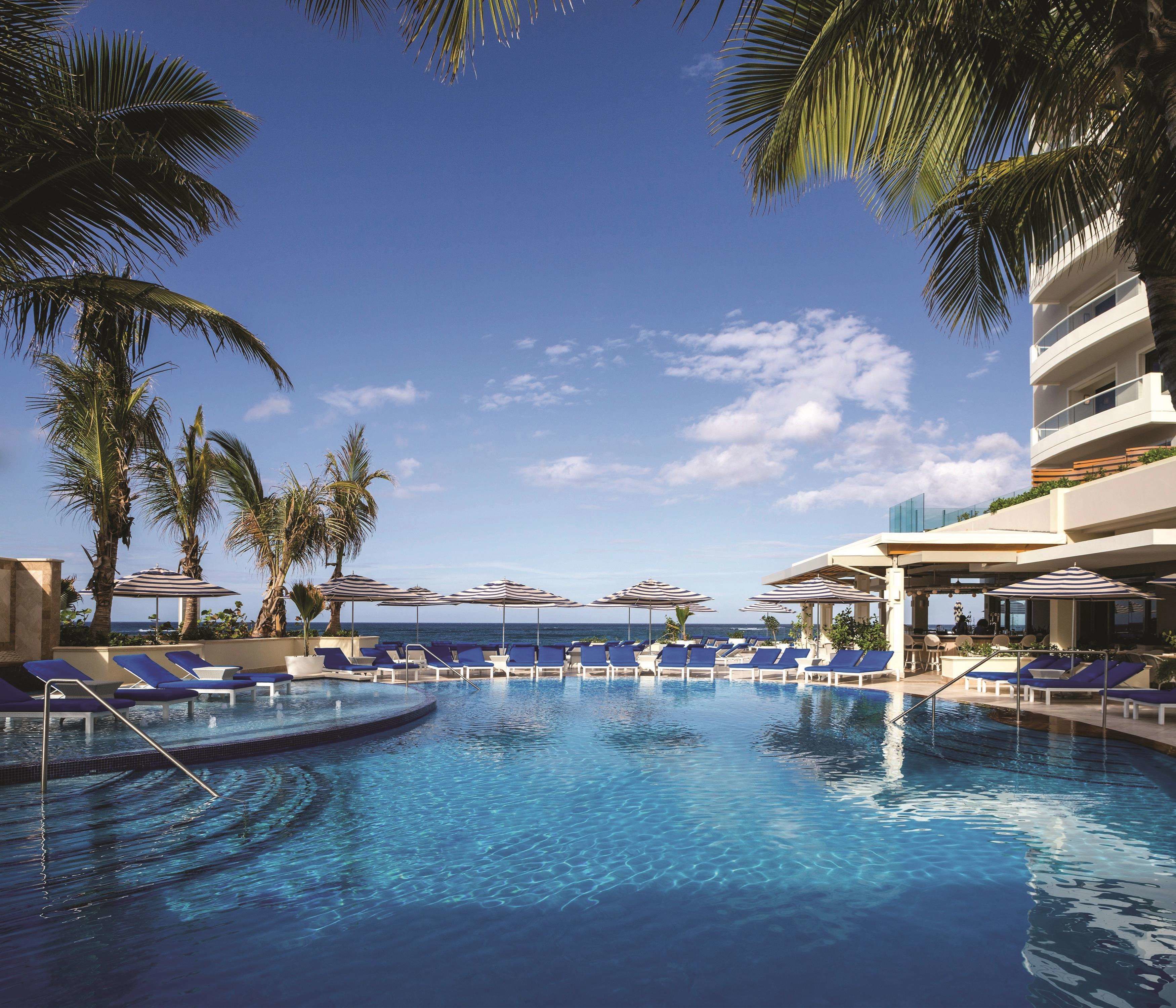 on the beach, white sand, beach cabanas, sun-loungers