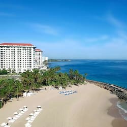 On the beach, white sand, beach cabanas, sun loungers