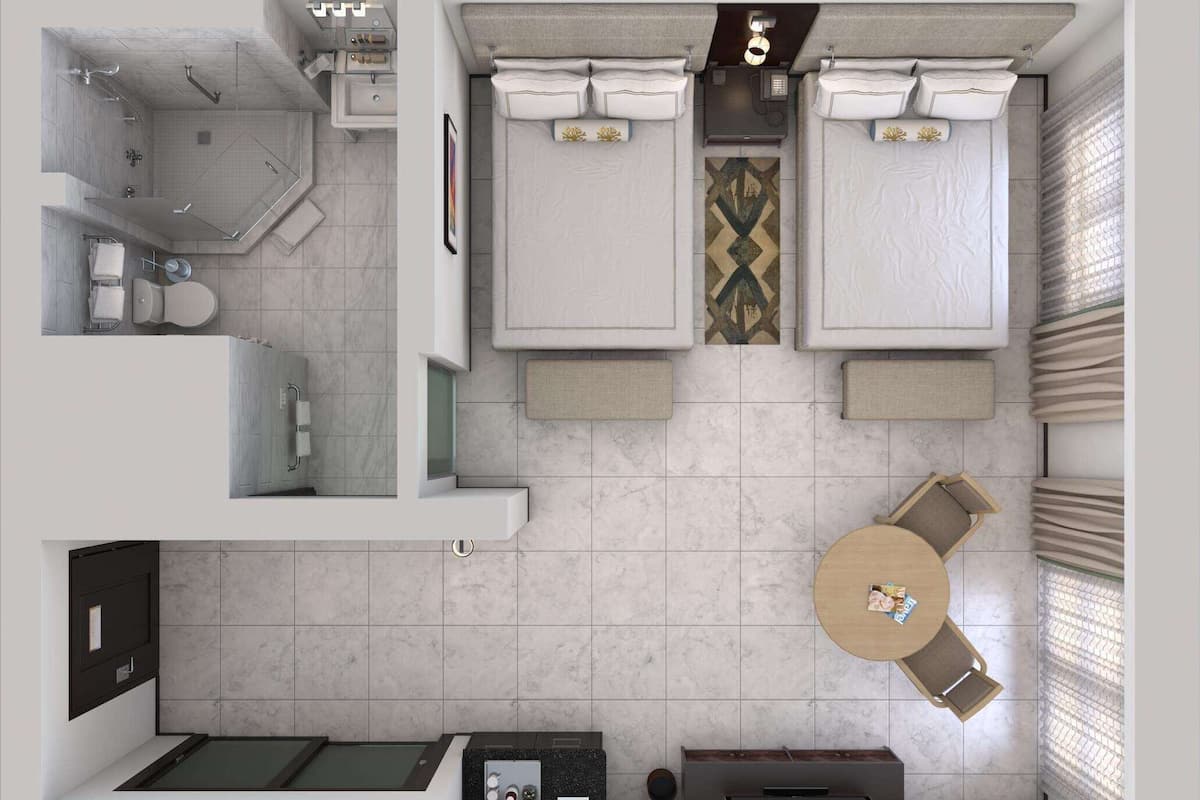 A compact hotel room with a shower, toilet, sink, and a small dining area with a table and chairs.