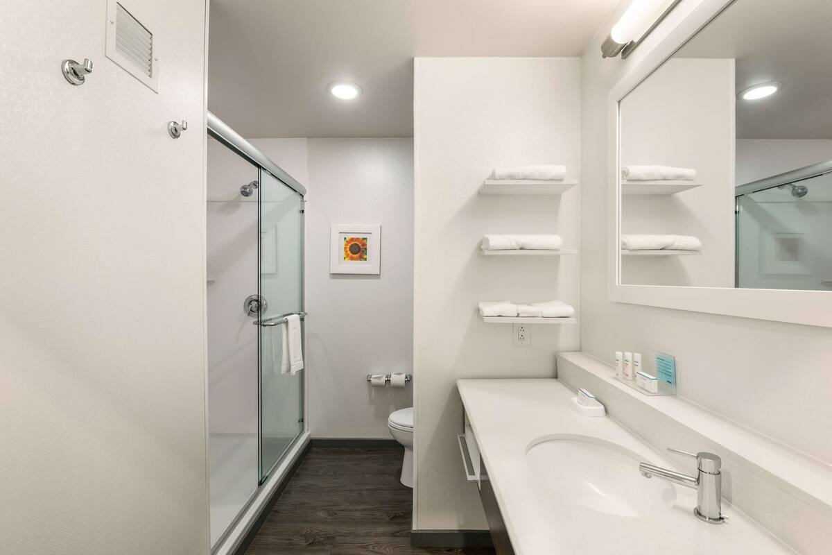 designer toiletries, hair dryer, towels