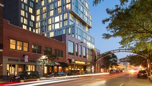 A modern building with multiple floors, large windows, and a prominent archway. - Le Méridien Columbus, The Joseph (Columbus)