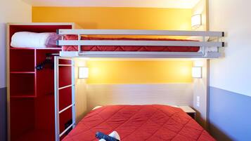 A bunk bed with a red mattress, a red wardrobe, and a bedside table with a remote control.