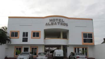 Hotel Albatros features a modern architectural design with a flat roof and a prominent entrance.