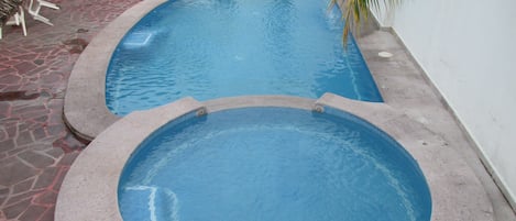 Piscina a l'aire lliure, para-sols i gandules