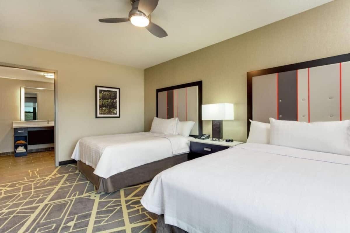 Premium bedding, desk, laptop workspace, blackout drapes