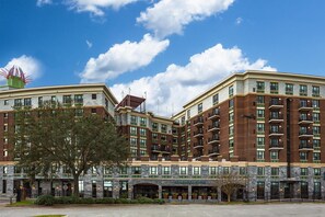 A multi-story hotel with a stone facade, multiple balconies, and a clear sky. - Homewood Suites by Hilton Savannah Historic Dist/Riverfront (Savannah)