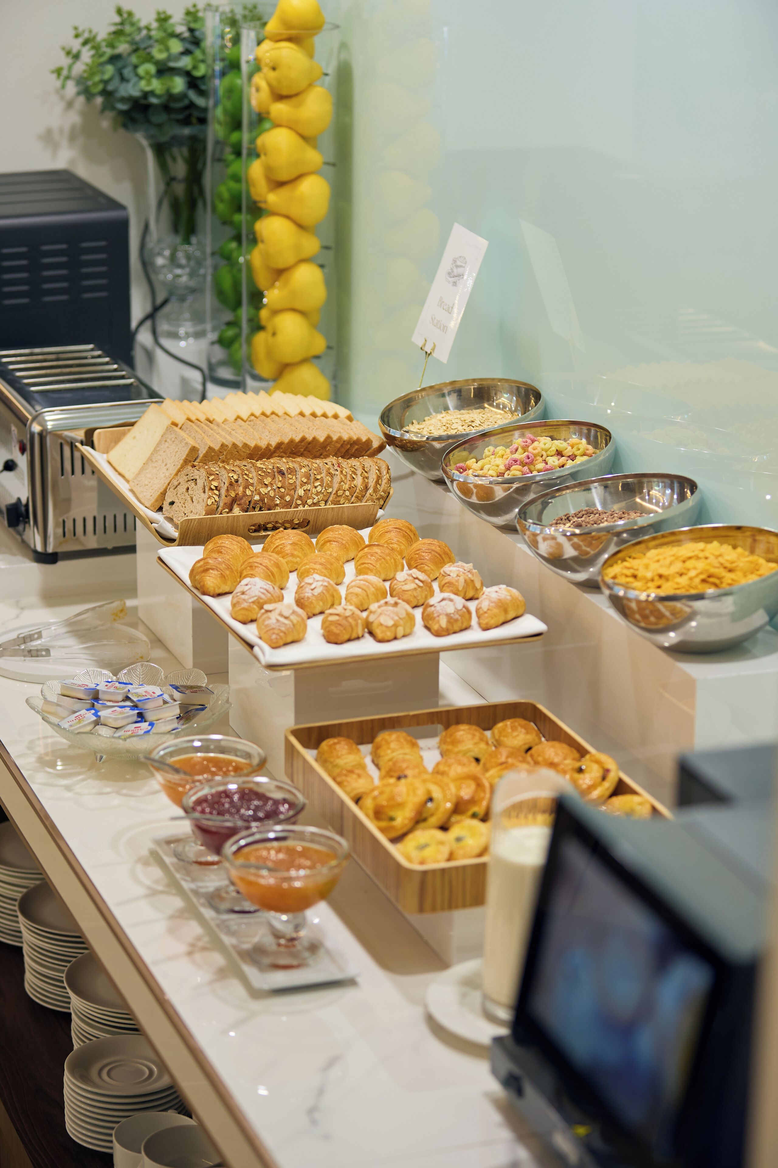 A buffet with various food items and a television screen.