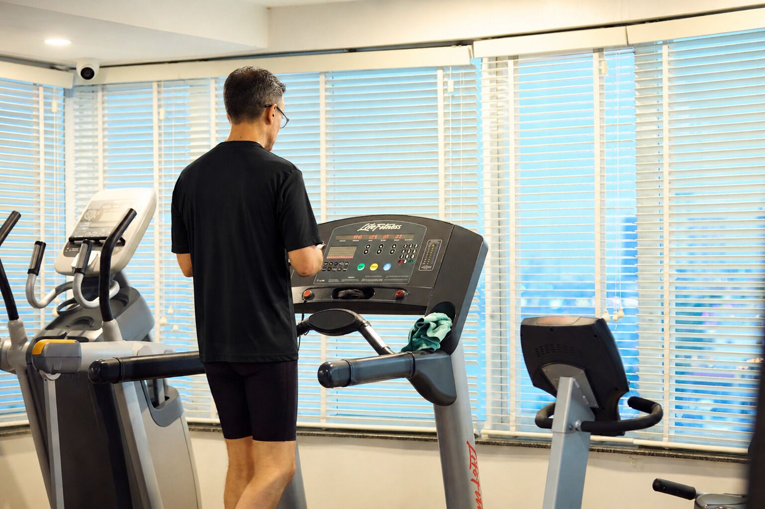 A gym with treadmills, a stationary bike, and a rowing machine.