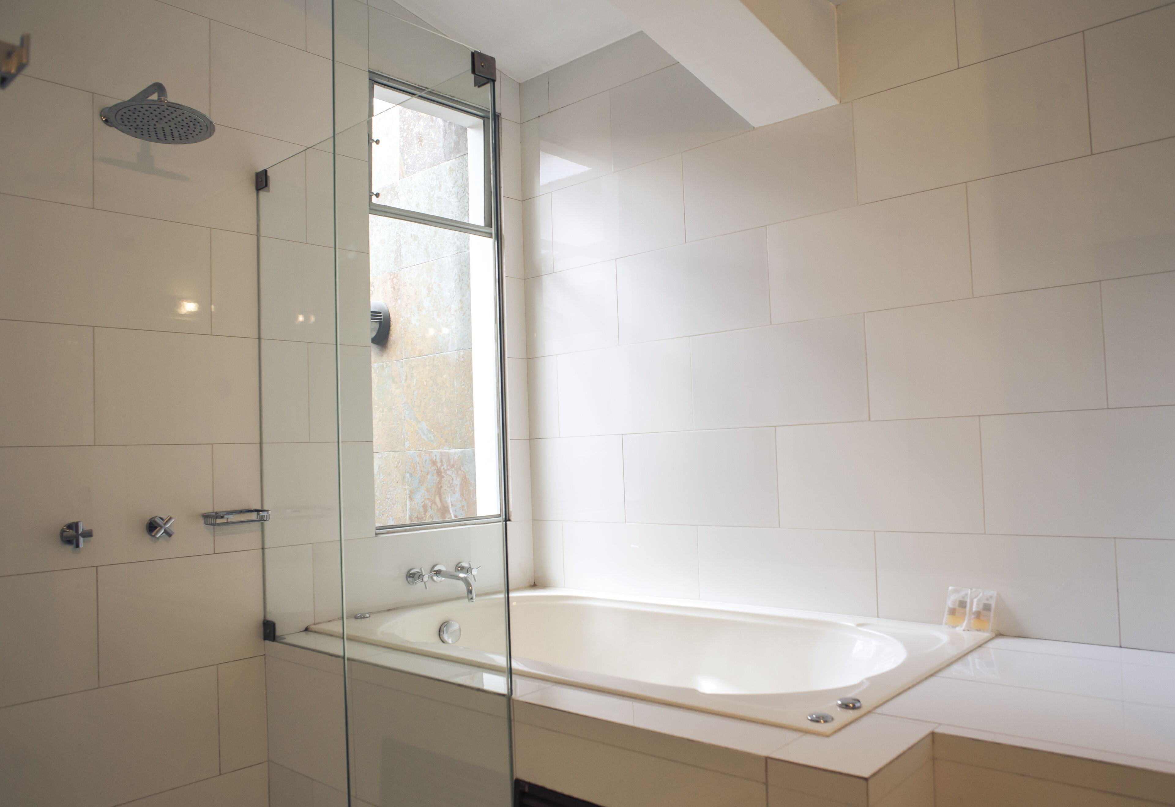 deluxe suite, jetted tub | bathroom | rainfall showerhead, free toiletries, hair dryer, bathrobes