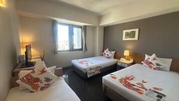 A hotel room with two beds, a desk with a computer, a window with curtains, a bedside lamp, and a wall-mounted picture.