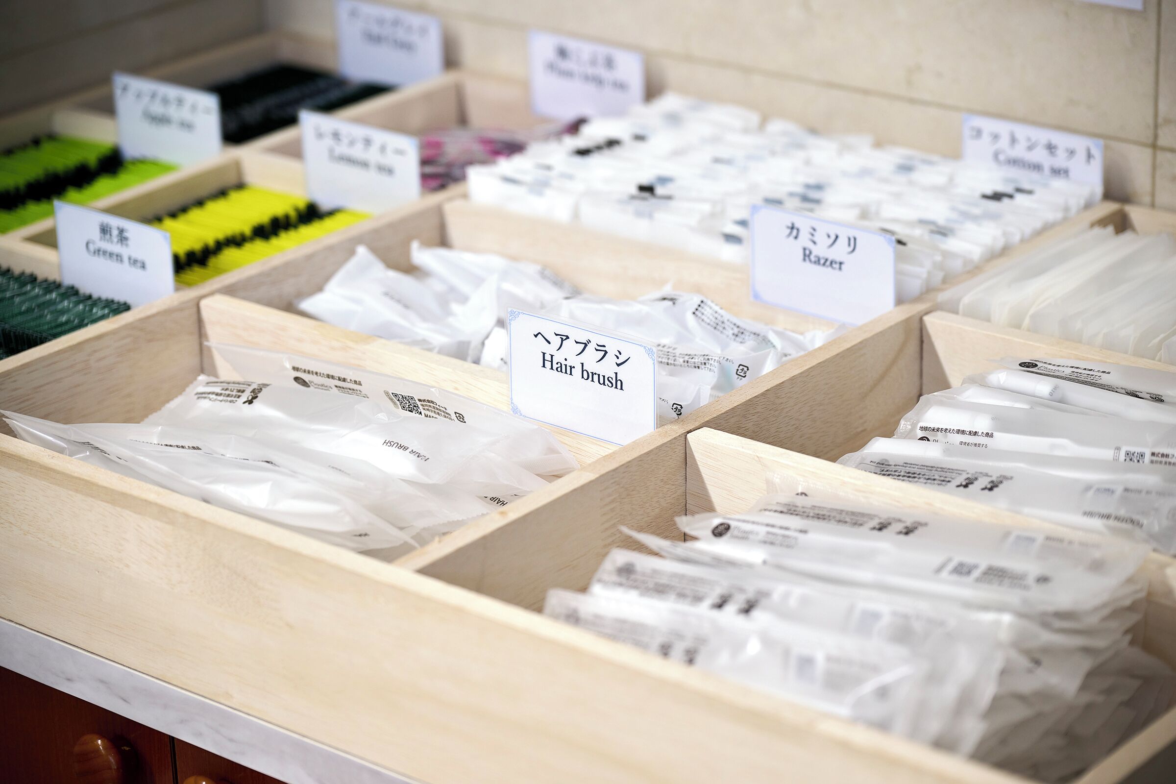 Wooden boxes with labeled compartments containing various hair care products.