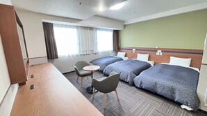 A hotel room with two beds, a small table, a chair, and a window with curtains. - Hotel 1-2-3 Kurashiki (Kurashiki)