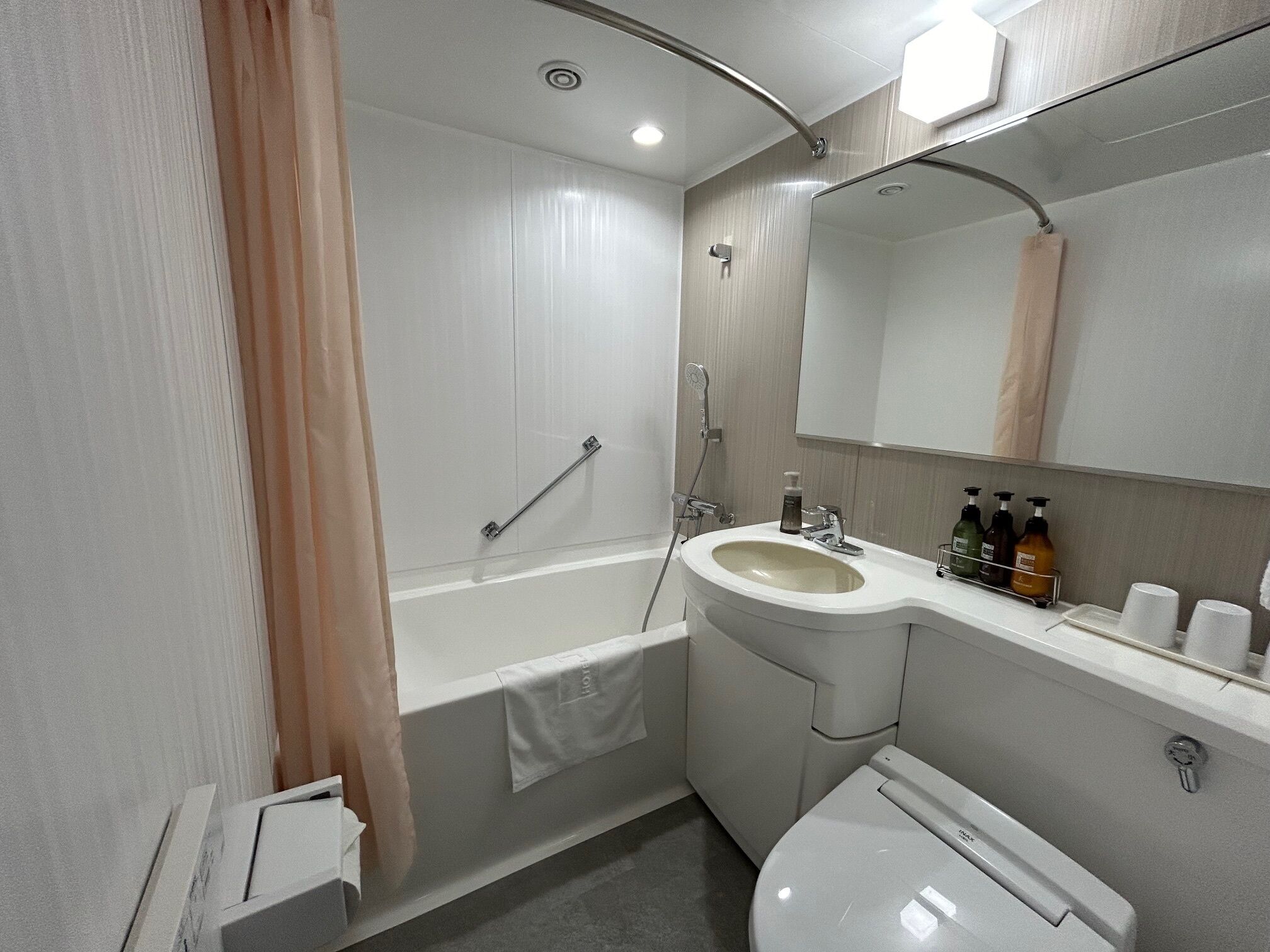 A modern bathroom with a bathtub, a sink, and a toilet.