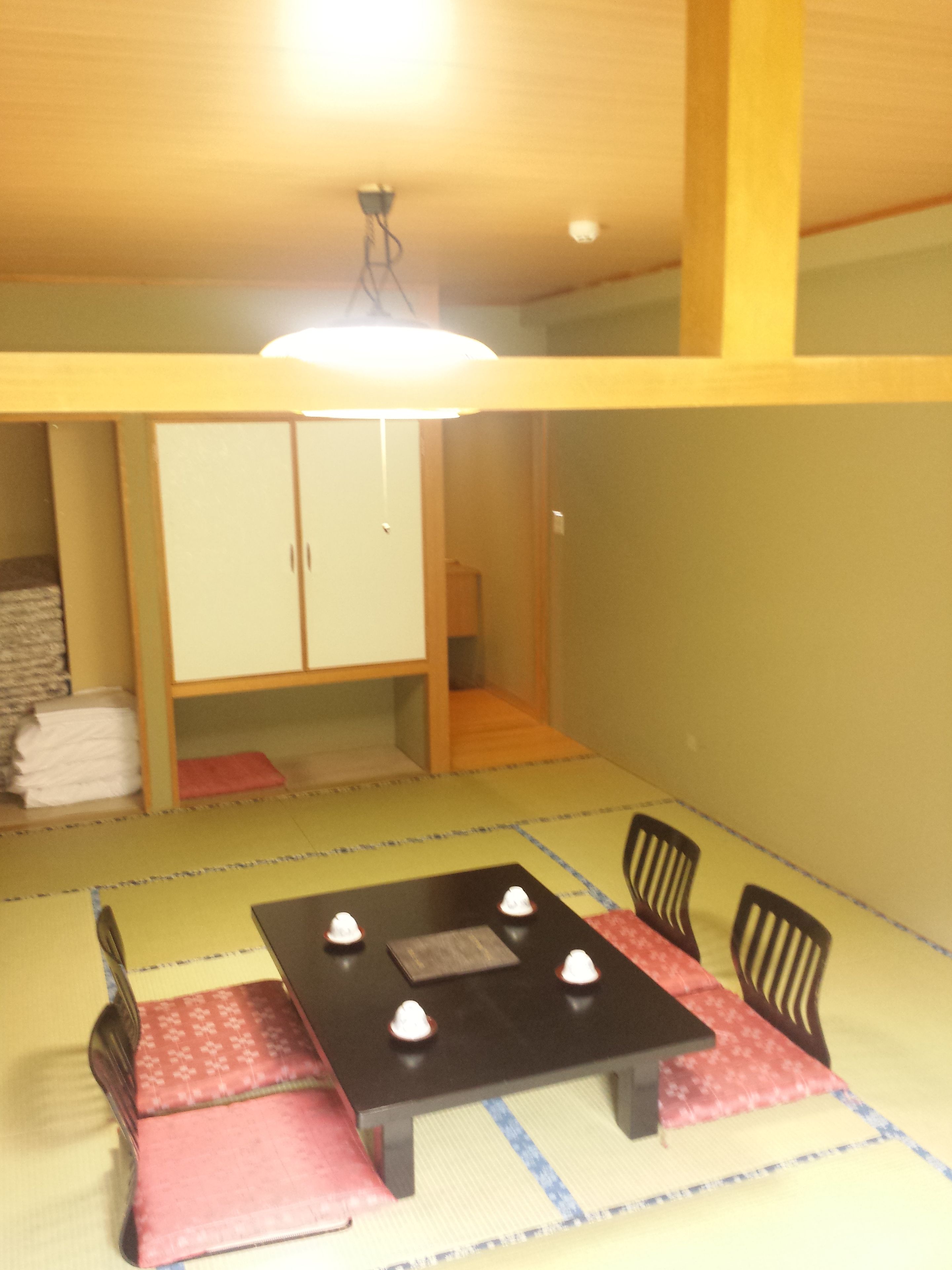 A dining area with a table, chairs, and a cabinet.