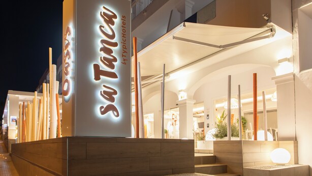 A hotel entrance with a sign reading "San Tano by Typichotels." - Oasis Sa Tanca Apartments by Typic Hotels (Santa Eulalia del Rio)