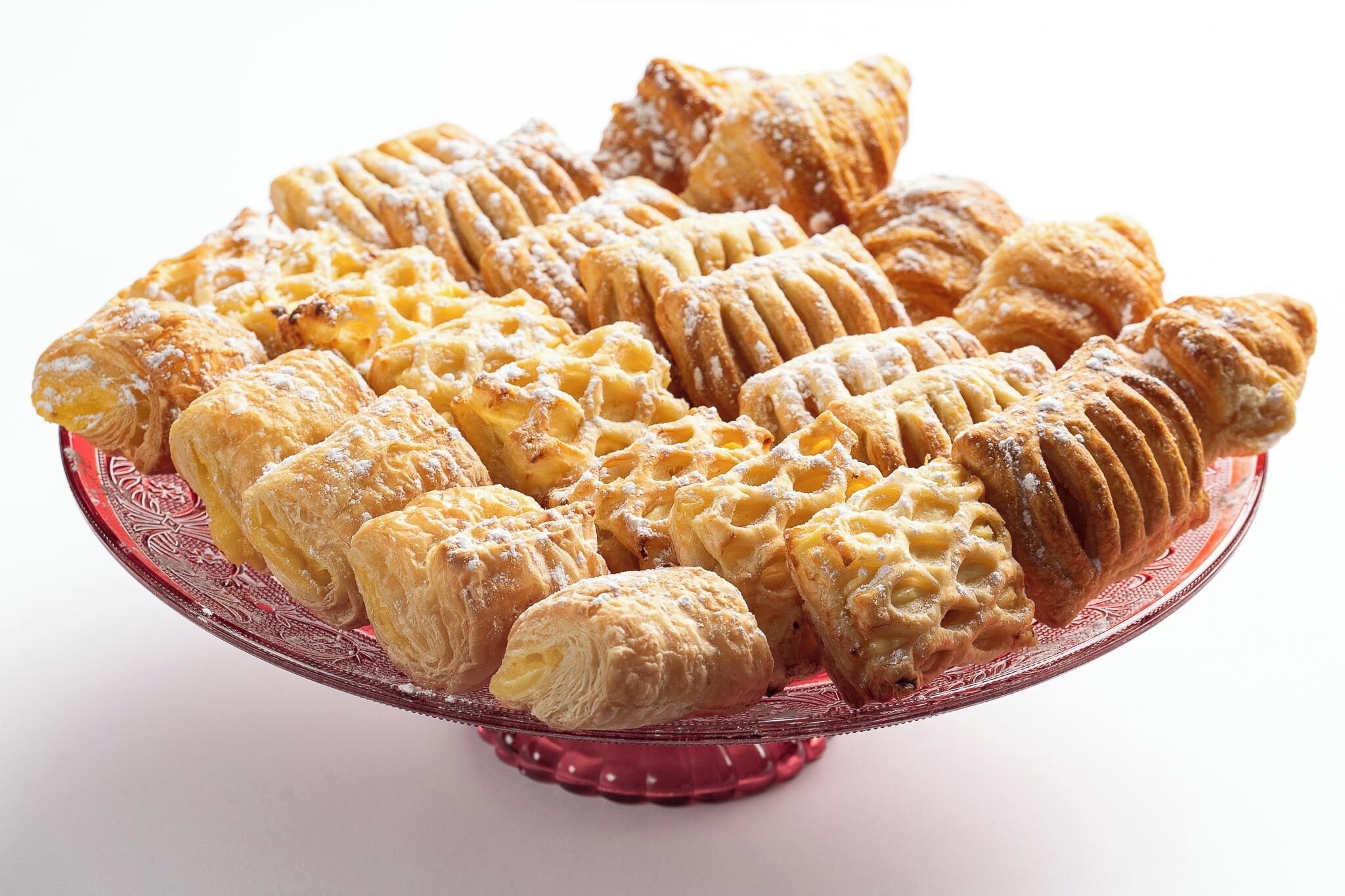A variety of pastries on a decorative plate.