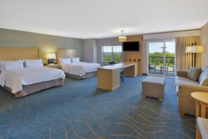 A hotel room with two beds, a desk, a sofa, and a TV. - Hampton by Hilton Bar Harbor (Bar Harbor)