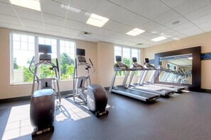 A gym with treadmills, elliptical machines, and a mirror wall. - Hampton by Hilton Bar Harbor (Bar Harbor)