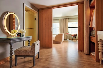 A double door with intricate carvings and a golden finish. at Sports Illustrated Resorts Chicago