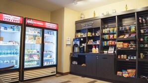 A convenience store with refrigerated beverage cases and shelves stocked with snacks and beverages. - Candlewood Suites Fort Collins by IHG (Fort Collins)