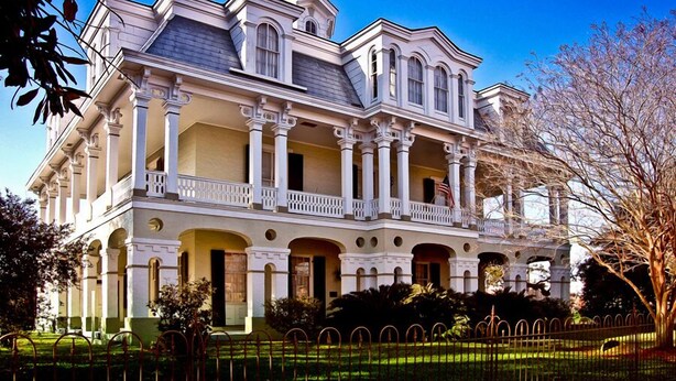 A large, stately building with multiple balconies and columns, likely a historic mansion or large estate. - The Dansereau House (Thibodaux)