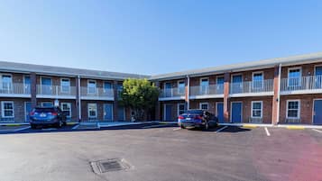 A multi-story motel with a parking lot.