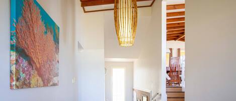 A staircase with wooden steps and a glass door at the top leading to another room.