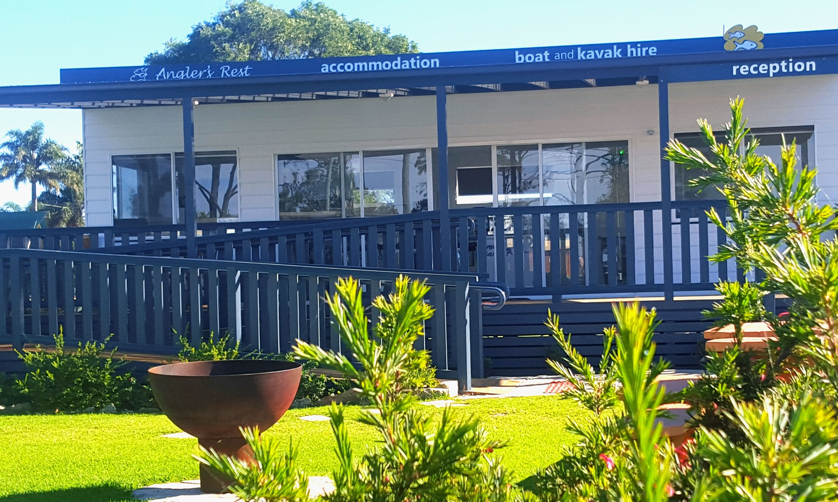 A building with a sign reading "Annal's Rest accommodation" and "boat and kayak hire" with a reception area.