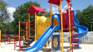 A playground with slides and climbing structures. - Hershey RV & Camping Resort (Lebanon)