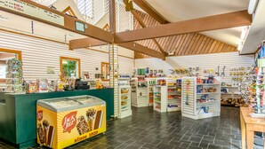 A Jack & Jill ice cream parlor with a green counter, various ice cream flavors, and a wooden ceiling. - Williamsburg RV & Camping Resort (Williamsburg)