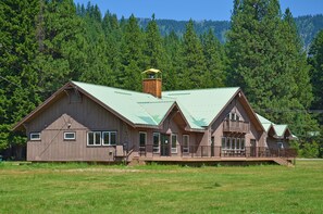 A wooden cabin with a green roof, a balcony, and a chimney. - Leavenworth RV Campground (Leavenworth)