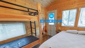 A wooden cabin with bunk beds, a single bed, and large windows. - Long Beach RV & Camping Resort (Ilwaco)