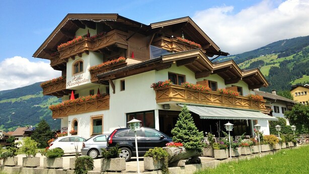 A traditional Alpine hotel with multiple balconies adorned with flowers, a visible restaurant sign, and a scenic mountain backdrop. - Hotel-Restaurant Rosengarten (Zell am Ziller)