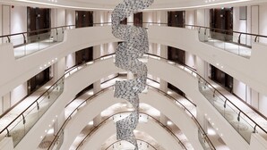 A multi-level atrium with a central spiral staircase and glass railings. - Hyatt Regency Istanbul Ataköy (Istanbul)