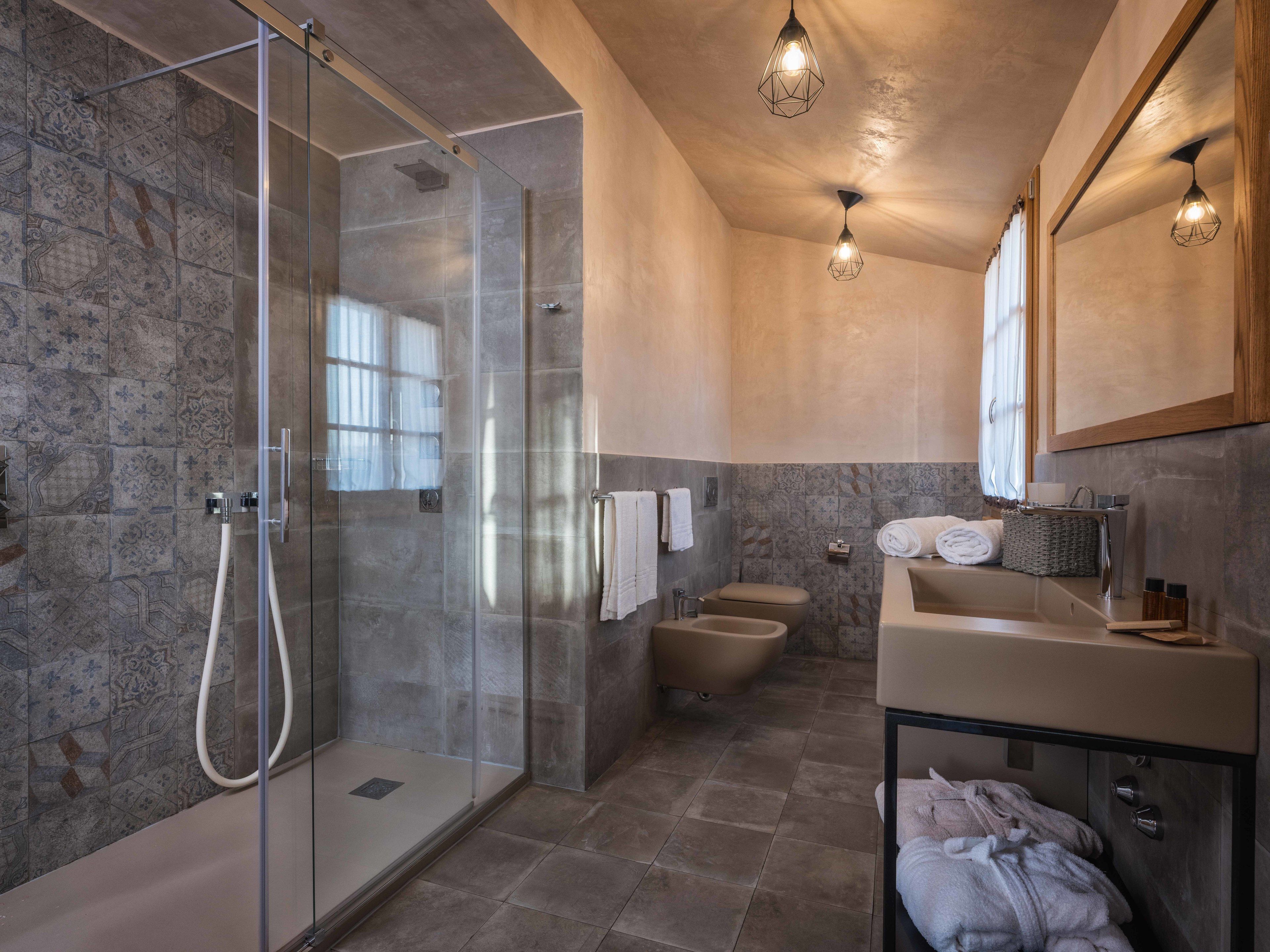 Une salle de bain moderne avec une douche à parois de verre, une baignoire et un meuble-lavabo avec un miroir.