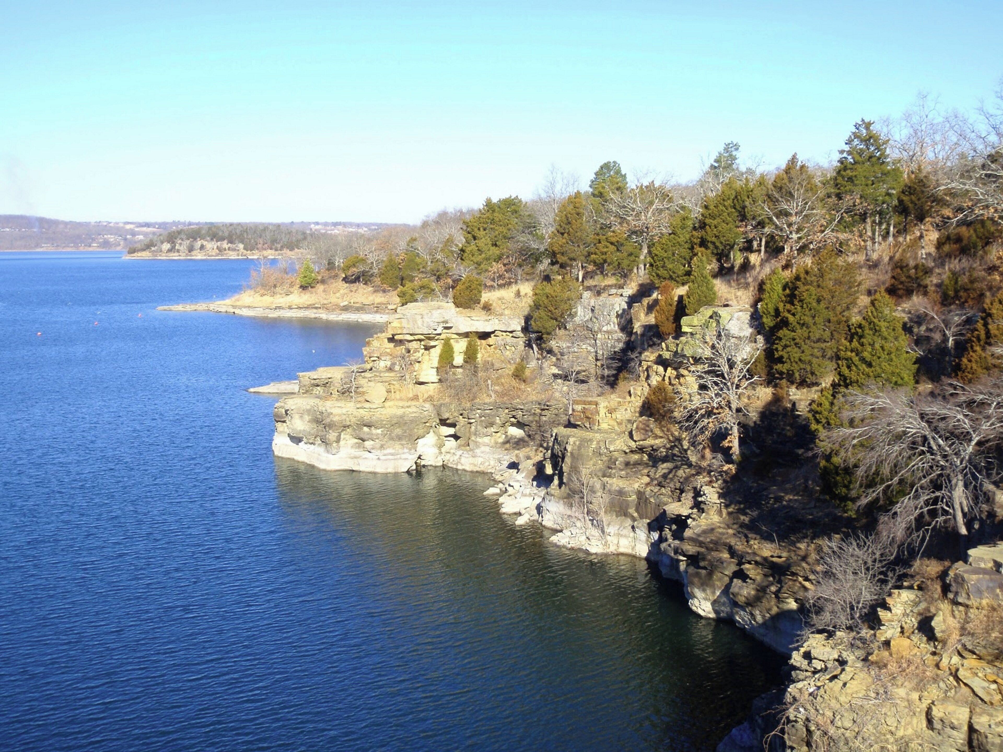 A coastal landscape with rocky cliffs and a body of water.