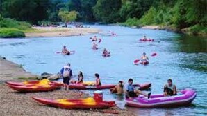 A group of people in kayaks and inflatable rafts on a river. - Holiday Inn Express & Suites Tahlequah by IHG (Tahlequah)